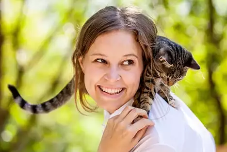 Woman with kitten on her shoulder